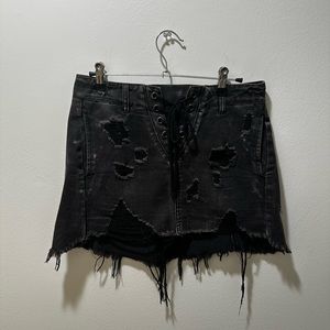 Distressed black denim mini skirt